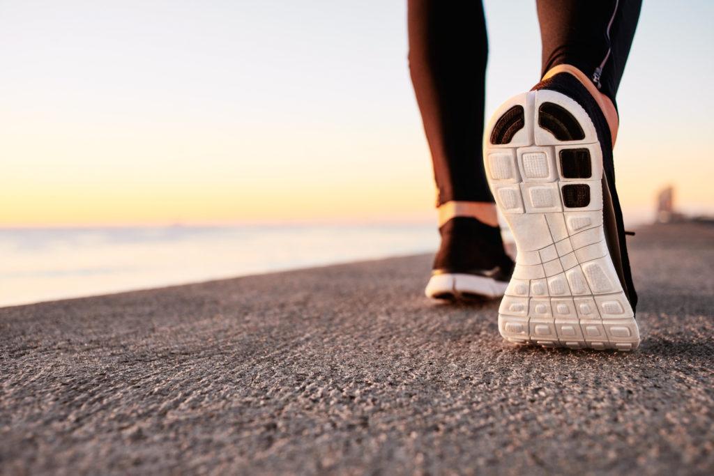 Runner man feet running on road 1024x683