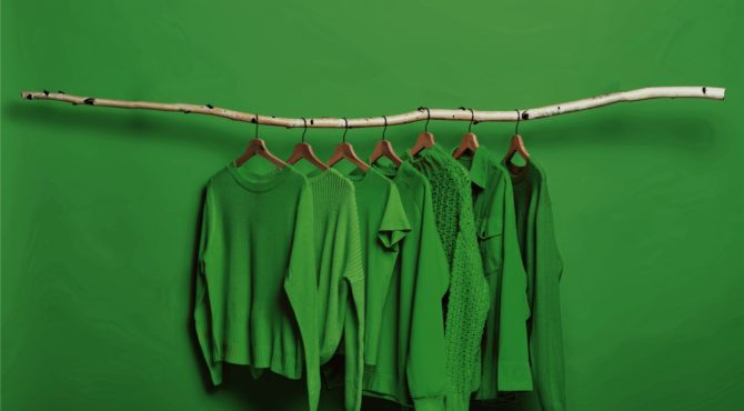 green clothing assortment on hangers
