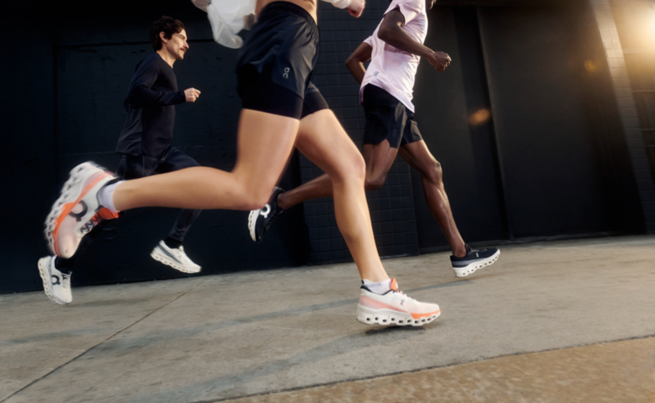 Cropped photograph of the lower half of two runners