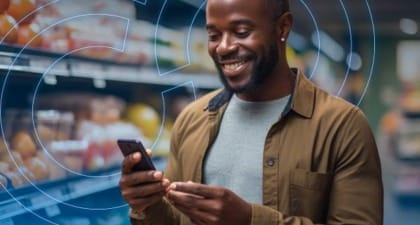 Man Looking at Phone in Grocery Store Produce Section