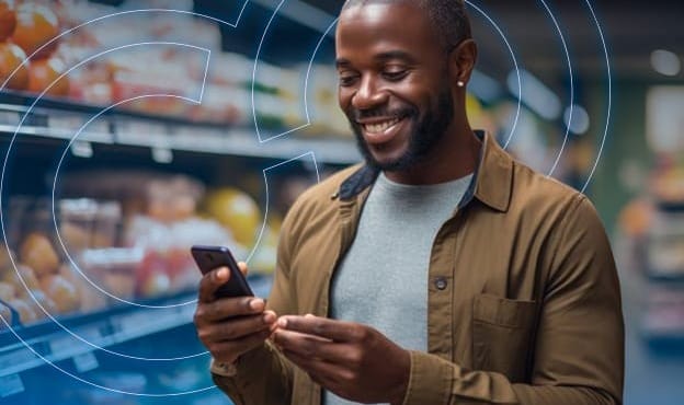 Man Looking at Phone in Grocery Store Produce Section