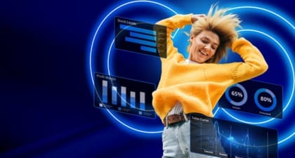 A person in a yellow sweater and jeans joyfully jumps with arms raised amidst digital graphs, stock levels, and sales curves. Blue neon rings highlight "3 Product Development Challenges You Must Solve in 2025—And How to Overcome Them Sustainably," blending innovation with excitement.