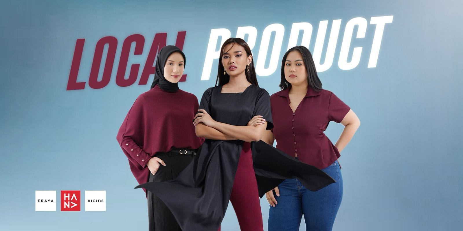 Tre donne sicure di sé, in abiti eleganti e moderni, si trovano davanti a uno sfondo blu con alle spalle la scritta "LOCAL PRODUCT" a grandi lettere, che promuove i marchi di moda locali ERAYA e HAND.